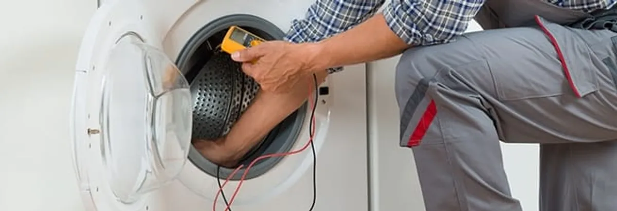 Dryer repair technician inspecting and repairing a clothes dryer in Bellevue, WA